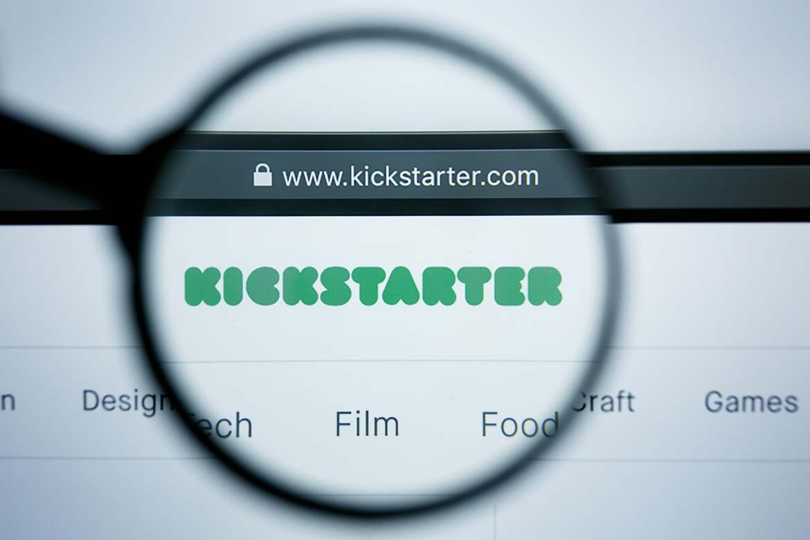 A magnifying glass over a computer screen opened to a Kickstarter web page (Iris)