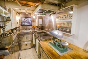 HONOLULU, OAHU, HAWAII, USA - AUGUST 21, 2016: kitchen preparation room with pots and plates of USS Bowfin Submarine SS-287 at Pearl Harbor. Historic Landmark of the Japanese attack in WW II