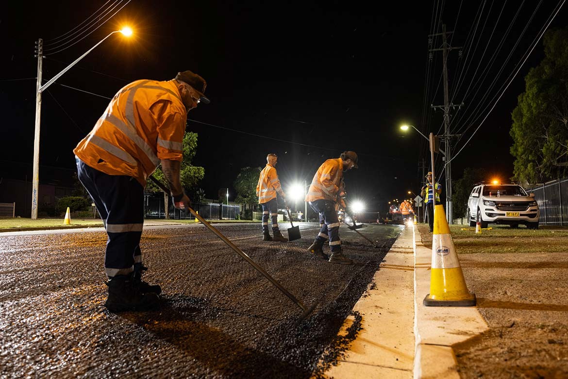 workers laying asphalt made with recycled coffee cups