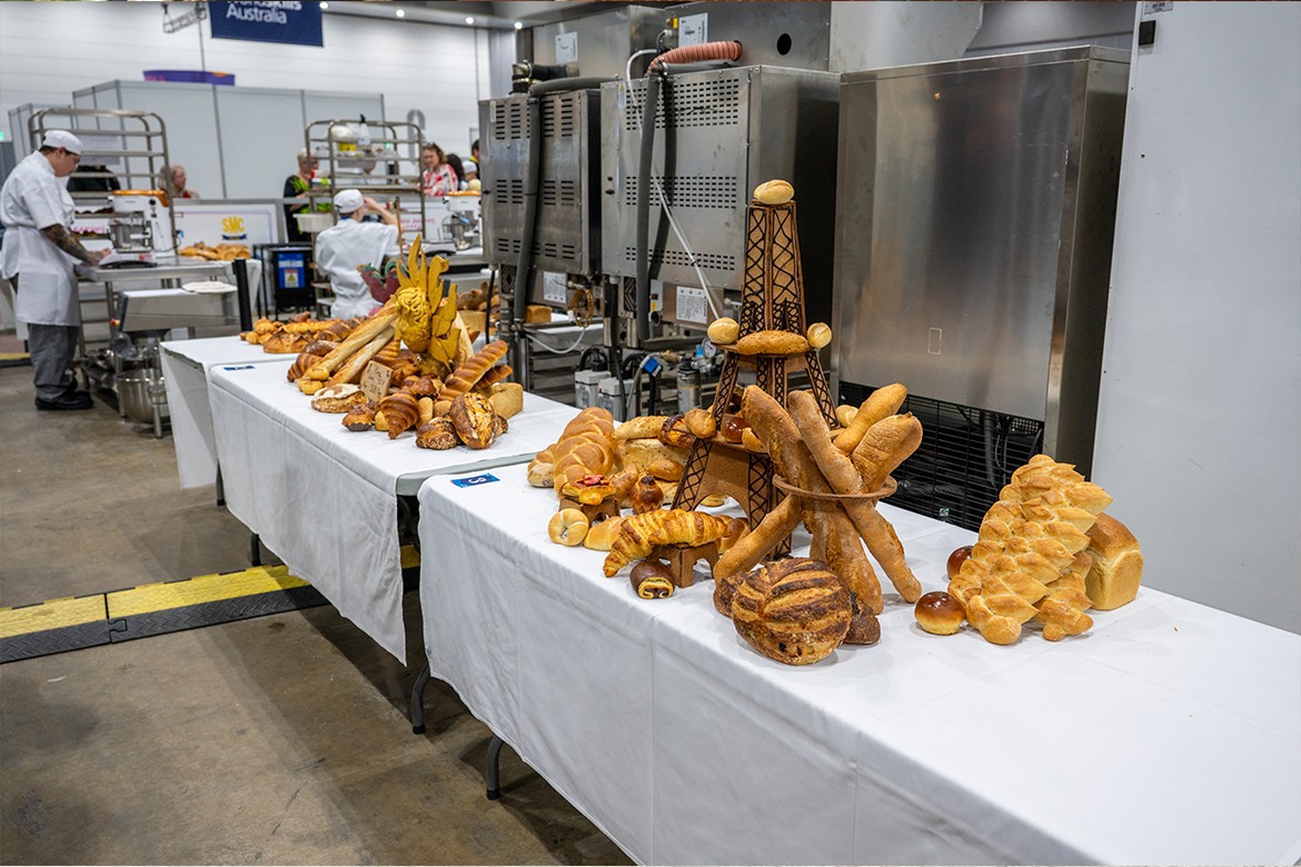 competition tables with bread stacked on them, in the foreground, the bread rolls are arranged in the shape of the Eiffel Tower (WorldSkills)