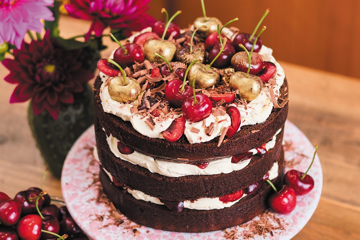black forest cake decorated with red and gold cherries